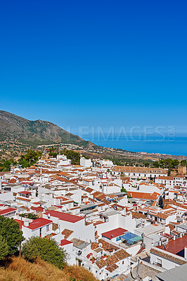 Buy stock photo Nature, buildings and town for travel, destination or holiday in Andalusia with vintage architecture. Location, blue sky and ancient houses outdoor in village for vacation, getaway or trip in Spain.