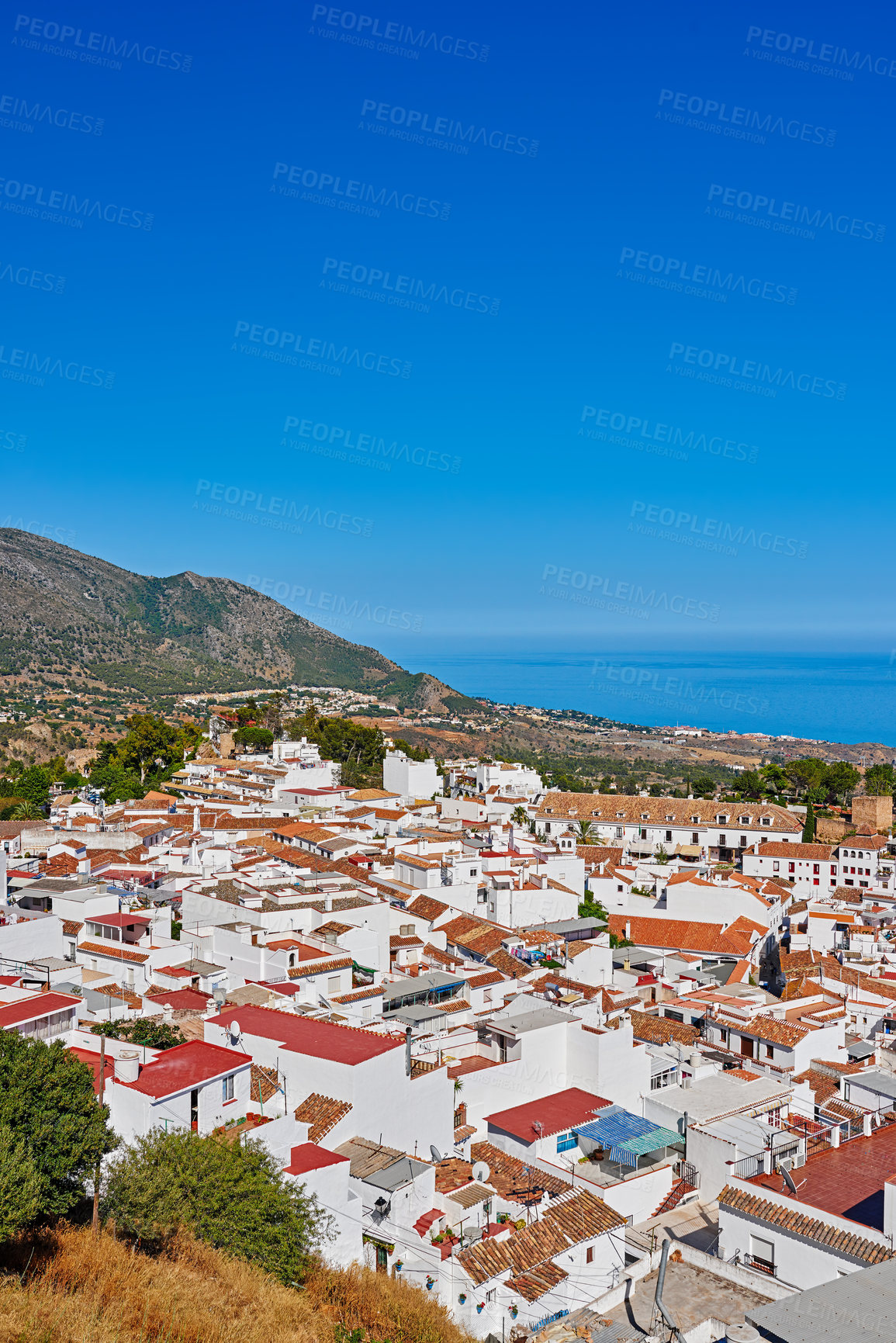 Buy stock photo Nature, buildings and town for travel, destination or holiday in Andalusia with vintage architecture. Location, blue sky and ancient houses outdoor in village for vacation, getaway or trip in Spain.