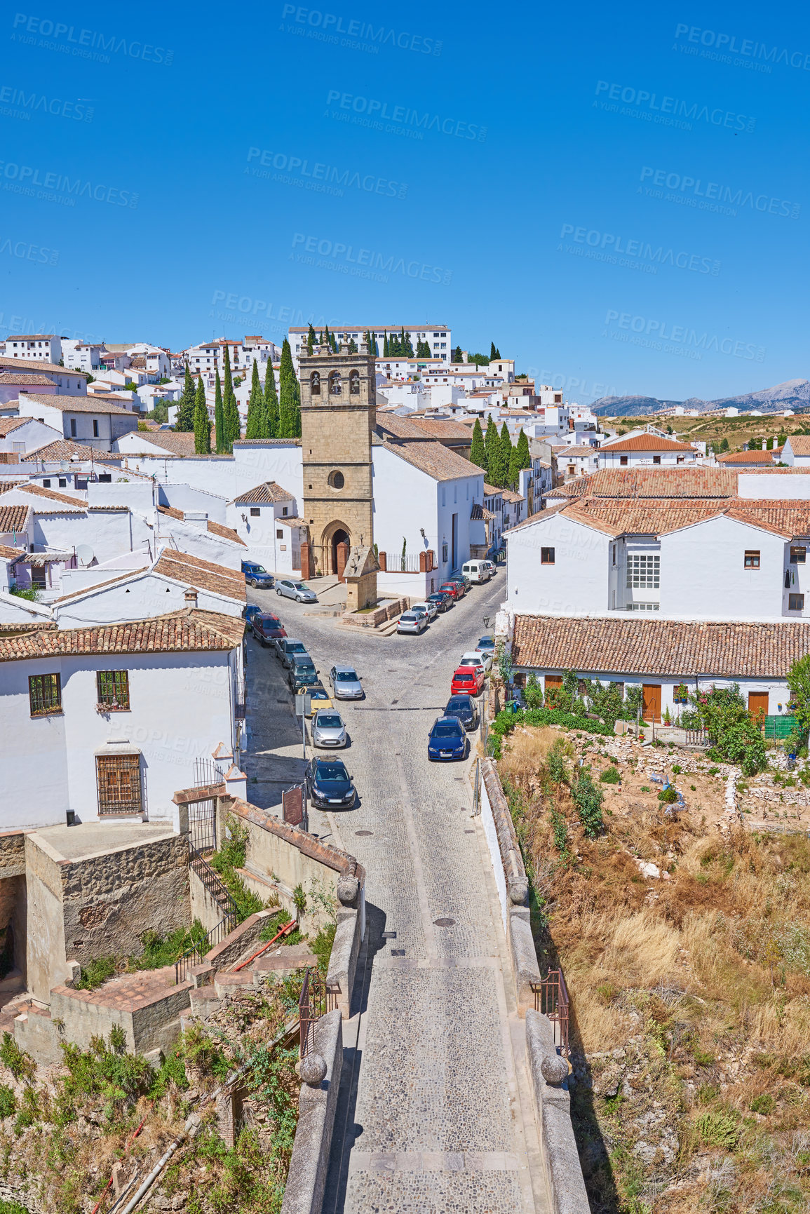 Buy stock photo Town, travel and outdoor for weekend trip in Ronda, Europe summer and trees for peace in city. Buildings, architecture and culture in Spain for tourism, holiday and calm environment on vacation