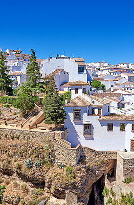 Buy stock photo Nature, buildings and city for holiday, destination or travel in Andalusia with vintage architecture. Location, blue sky and ancient houses outdoor in village for vacation, getaway or trip in Spain.