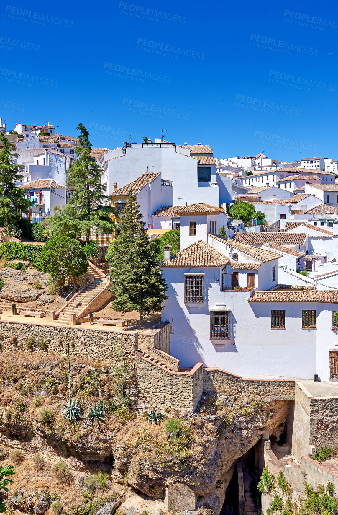 Buy stock photo Nature, buildings and city for holiday, destination or travel in Andalusia with vintage architecture. Location, blue sky and ancient houses outdoor in village for vacation, getaway or trip in Spain.