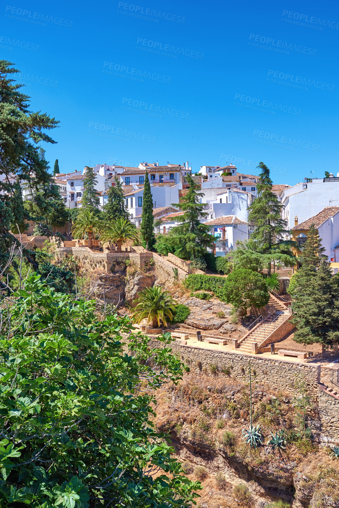 Buy stock photo Blue sky, buildings and city for travel, destination or holiday in Andalusia with vintage architecture. Location, nature and ancient houses outdoor in village for vacation, getaway or trip in Spain.