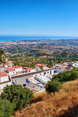 Buy stock photo Outdoor, buildings and village in nature, sky and architecture of homes, above and neighbourhood. Cliff, mockup space and peace of countryside, property and history of real estate, scenery and Spain