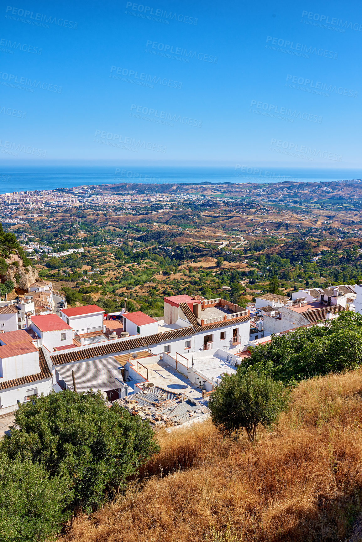 Buy stock photo Outdoor, buildings and village in nature, sky and architecture of homes, above and neighbourhood. Cliff, mockup space and peace of countryside, property and history of real estate, scenery and Spain