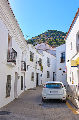 Buy stock photo Car, house and street in neighborhood with traditional architecture in Spain. Outdoor, home and alley in village with cultural or vintage design as holiday or vacation destination for tourism