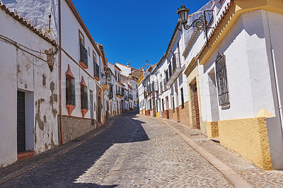 Buy stock photo Outdoor, houses and street in neighborhood with traditional architecture in Spain. Outside, home and road in village with cultural or vintage design as holiday or vacation destination for tourism