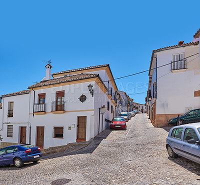 Buy stock photo Outdoor, houses and street with cars with traditional architecture in Italy. Outside, neighborhood and road in village with cultural or vintage design as holiday or vacation destination for tourism