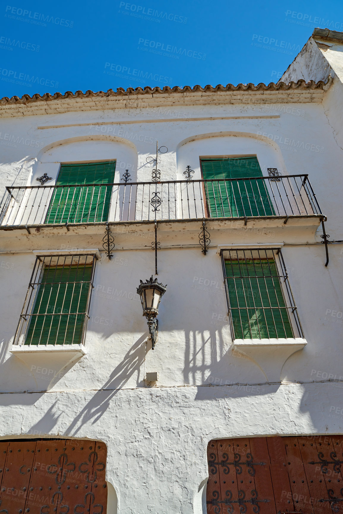 Buy stock photo Balcony, buildings and ancient house with blue sky for wall structure, travel location and history architecture. Above, property and window view, fence construction and vintage frame of Spain holiday