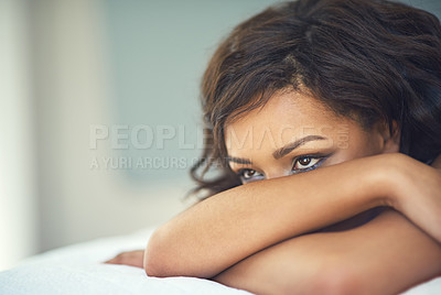 Buy stock photo Shot of a beautiful young woman relaxing in lingerie on her bed
