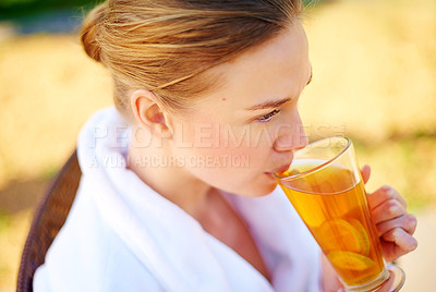 Buy stock photo Shot of a young woman having a drink at a spa