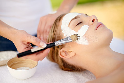 Buy stock photo Shot of a young woman getting a facial at a spa