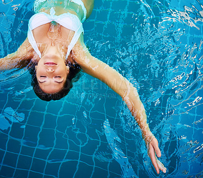 Buy stock photo Shot of a young woman relaxing at a spa pool