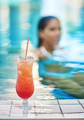 Buy stock photo Shot of a a young woman relaxing by a swimming pool