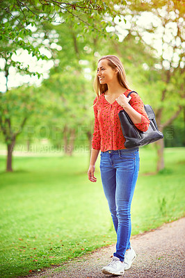 Buy stock photo Shot of a young woman on a walk through the park
