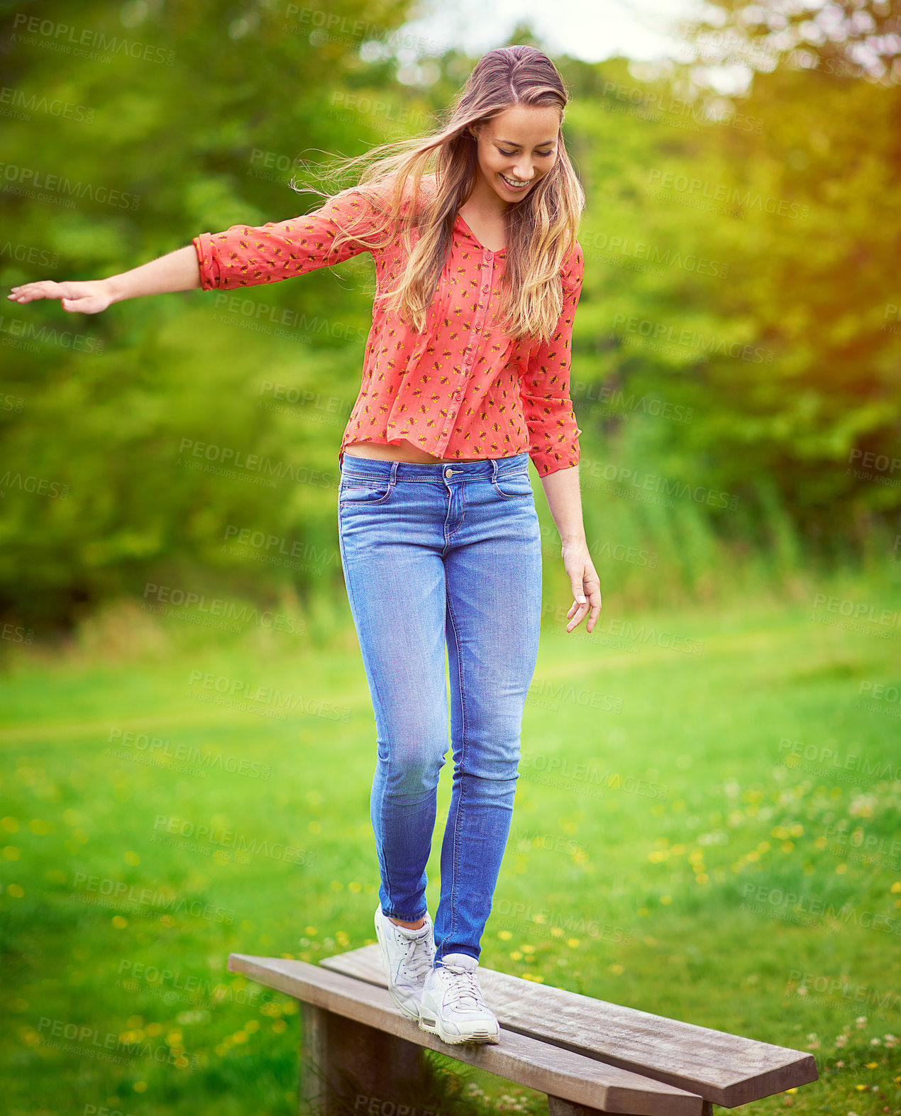 Buy stock photo Balance, happy and woman in park for holiday, adventure and walking on bench in backyard. Smile, female person and vacation or playing in countryside on weekend or grass in nature or field for spring