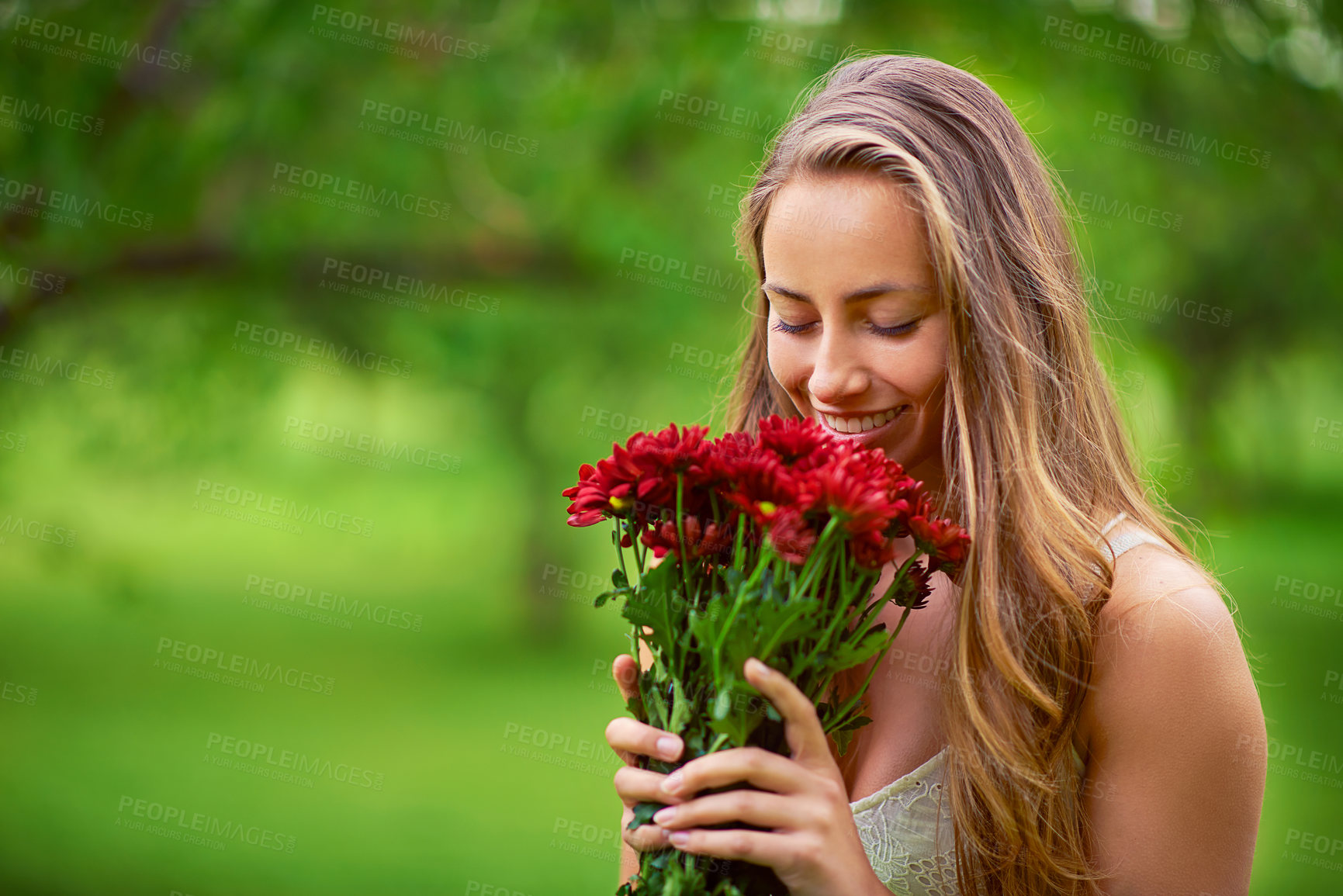 Buy stock photo Nature, woman and happy for smelling flowers, summer time and eco friendly gift with mockup. Female person, smile and chrysanthemum bouquet with space for scent, floral present and ecology in park