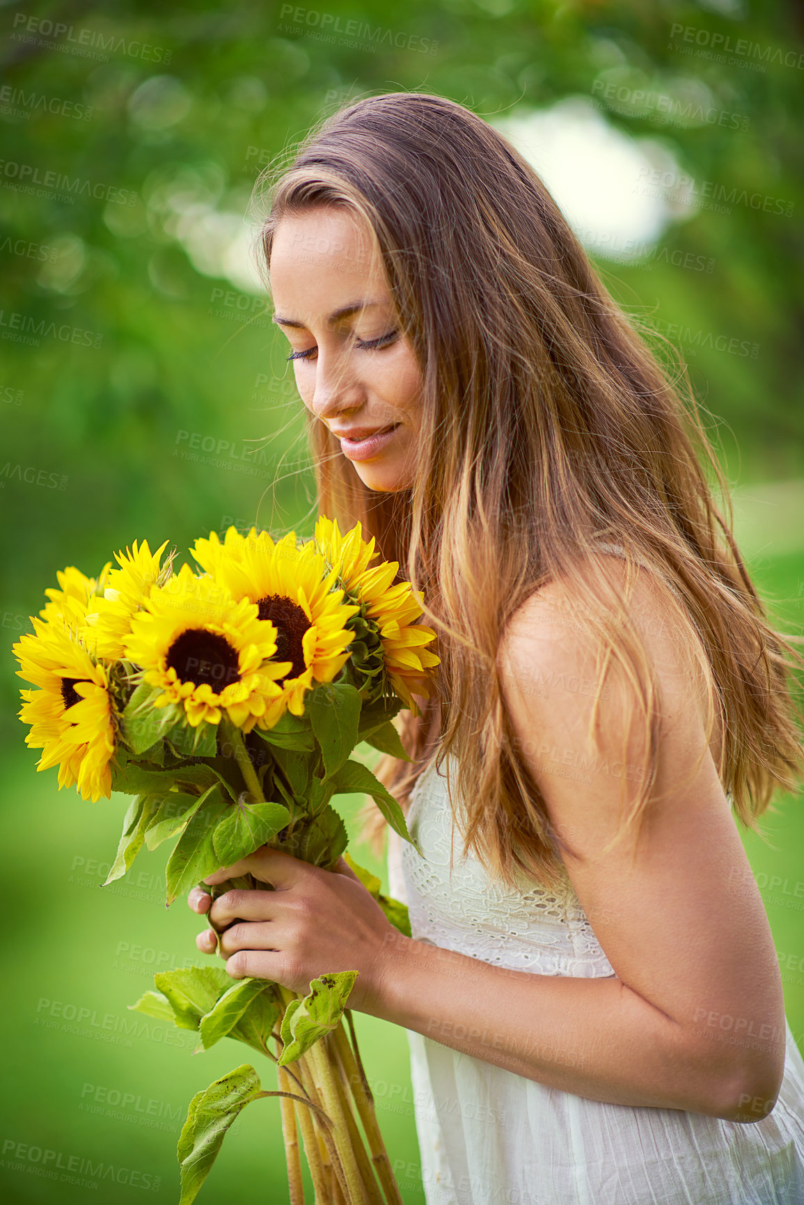 Buy stock photo Nature, woman and bouquet of sunflowers with summer time, scent and ideas for floral present. Female person, relax and flowers in park with eco friendly gift for smelling, spring and sustainability