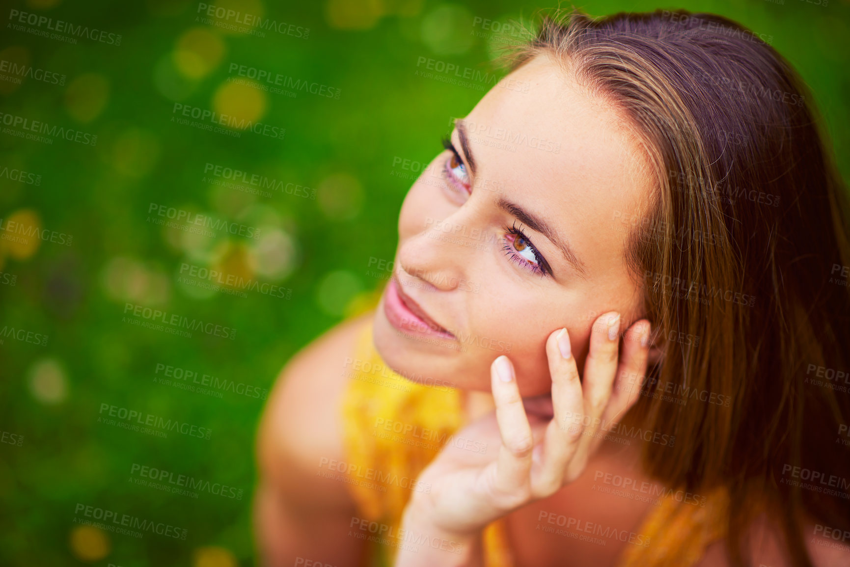 Buy stock photo Cropped shot of a thoughtful young woman at the park