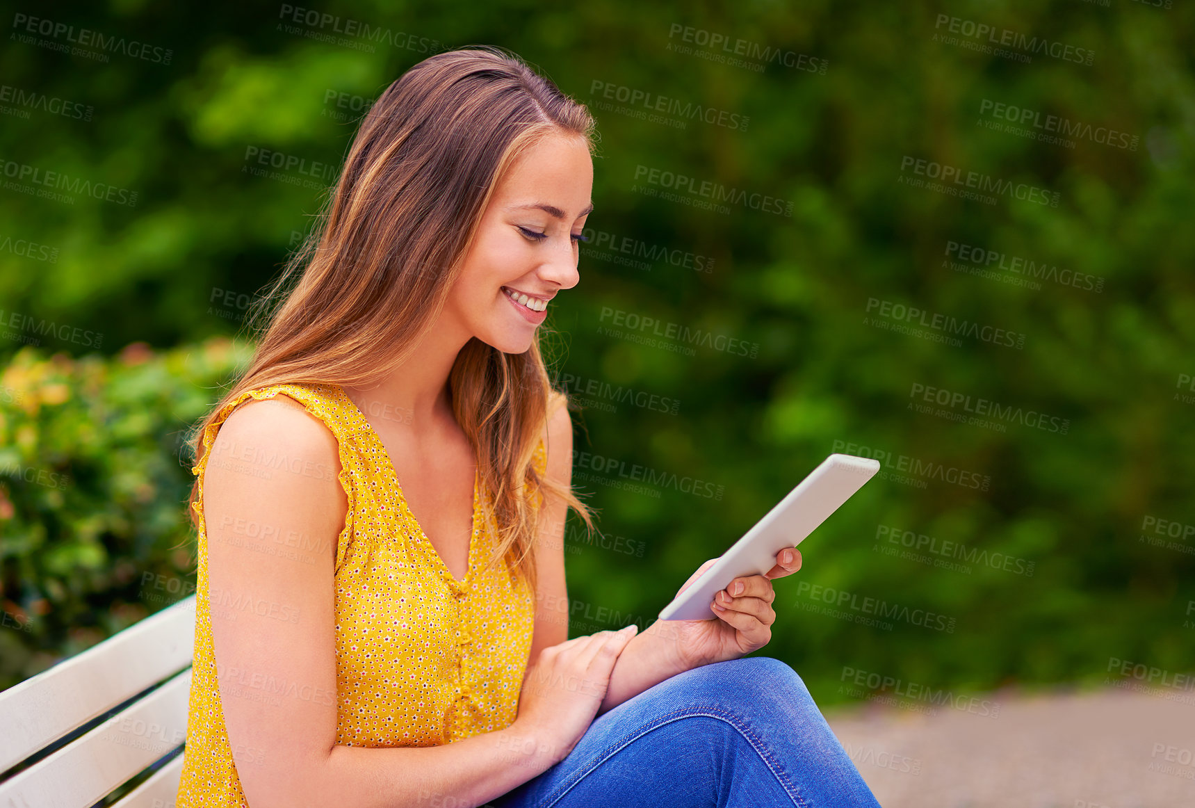 Buy stock photo Happy, woman and tablet in park for reading, research and networking for school project. College student, smile and technology on bench or campus for social media, communication and online or ebook