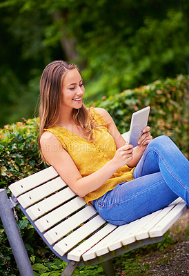 Buy stock photo Outdoor, woman and tablet in garden for reading, research and networking for school project. College student, happy and technology on bench in park for social media, communication and online or ebook