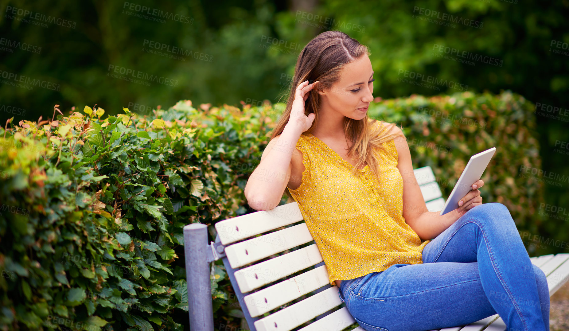 Buy stock photo Reading, woman and tablet on bench for ebook, research and networking for school project. College student, happy and technology on campus or park for social media, communication and online for scroll