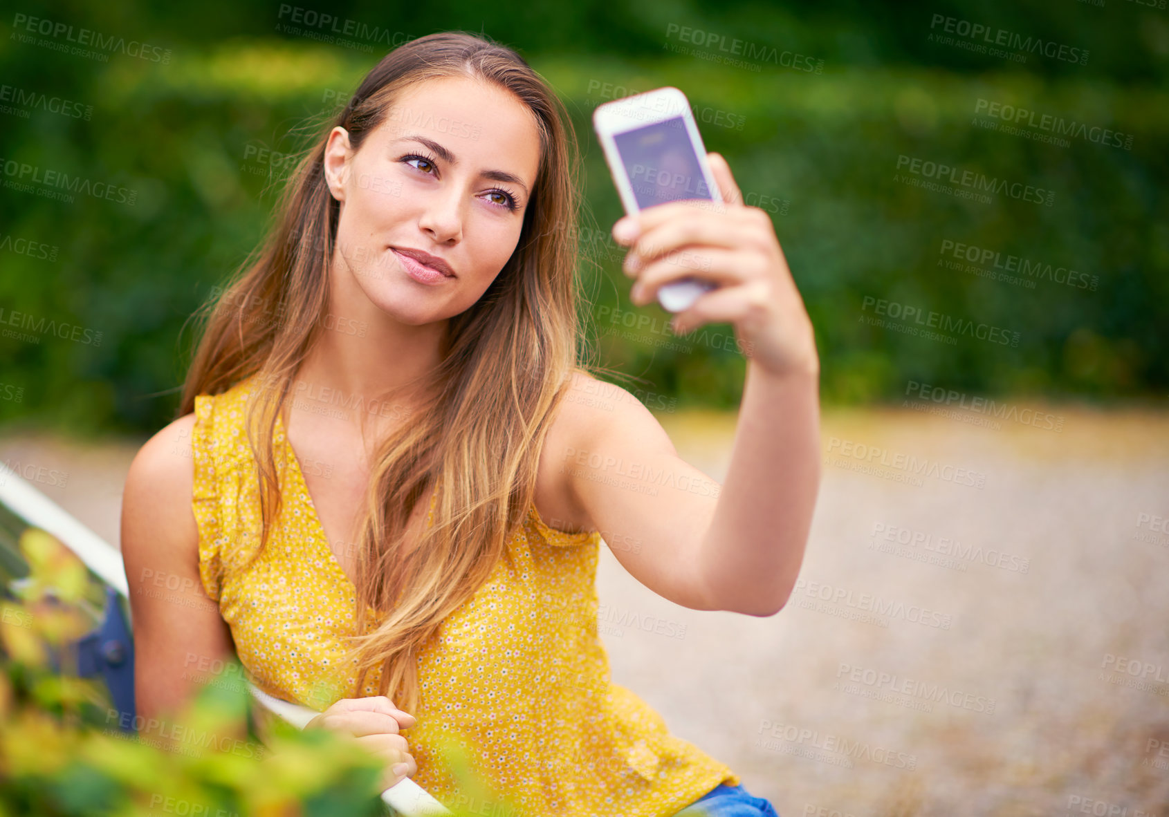 Buy stock photo Nature, relax and woman with selfie in garden for memory, photograph or social media post. outdoor, smile and female person on bench for happiness, profile picture or peaceful weekend in park