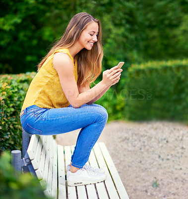 Buy stock photo Woman, park and smile with smartphone on social media or online dating for networking and fun. Female person, outdoor and happy with waiting for date on mobile app for communication in New York