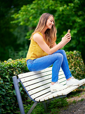 Buy stock photo Woman, park and happy with smartphone on social media or online dating for networking and fun. Female person, outdoor and smile with waiting for date on mobile app for communication in New York