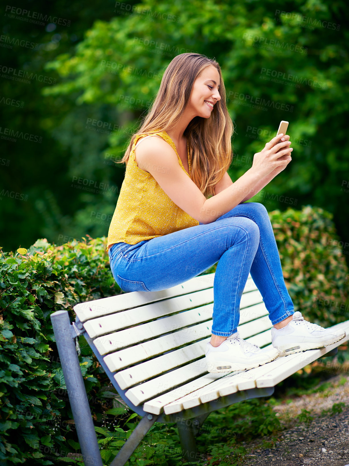 Buy stock photo Woman, park and happy with smartphone on social media or online dating for networking and fun. Female person, outdoor and smile with waiting for date on mobile app for communication in New York
