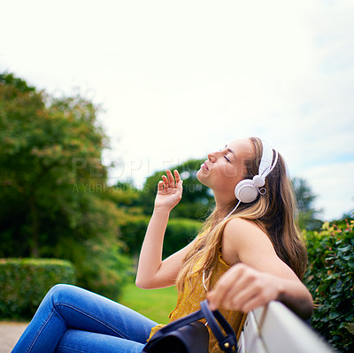 Buy stock photo Outdoor, relax and woman with headphones in park for streaming service, listening to music or radio. Nature, enjoy and person with eyes closed on bench for playlist, peaceful or weekend break