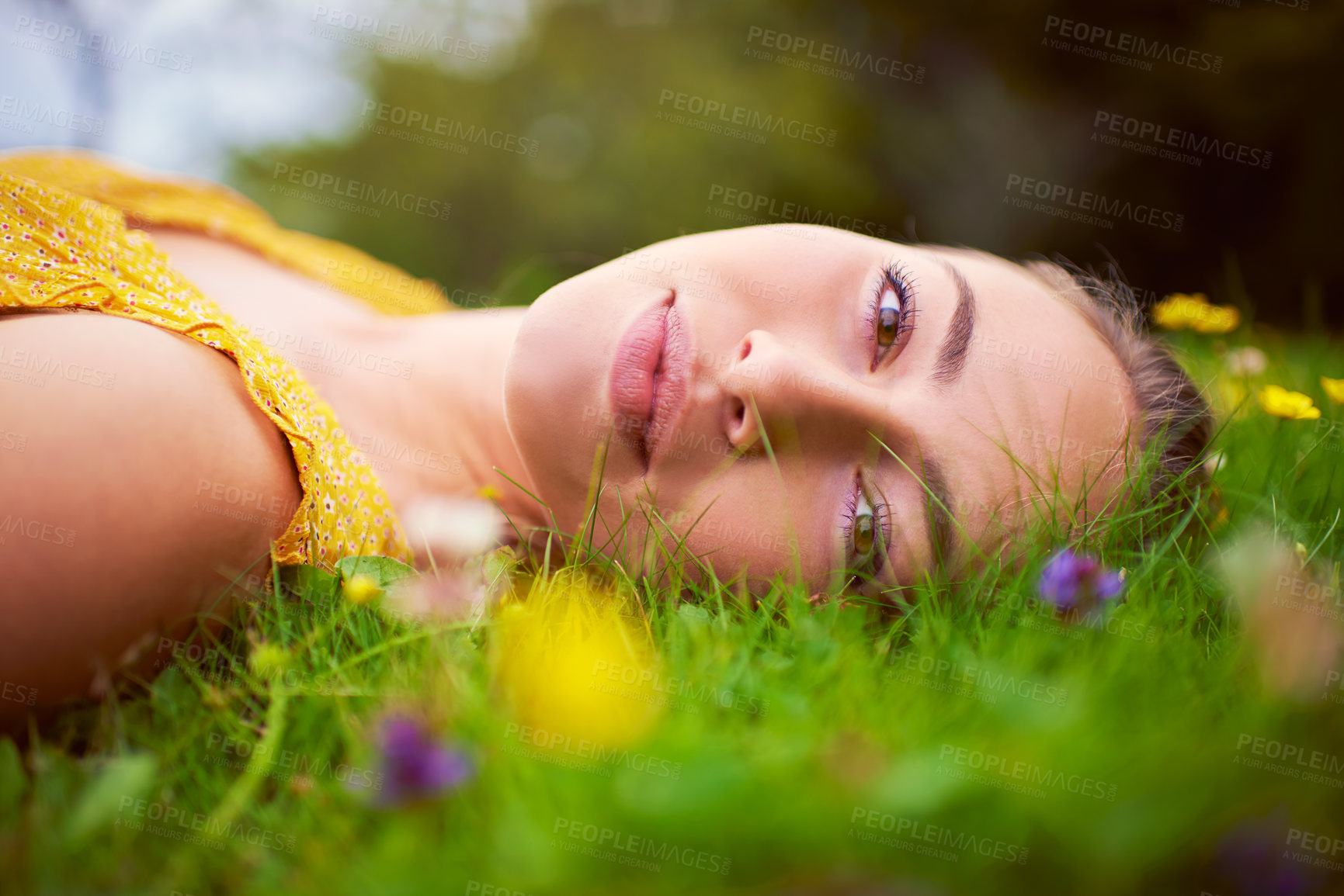 Buy stock photo Woman, portrait and relax on grass outdoor, travel and countryside nature for peace or calm. Female person, rest and field or meadow for wellness, spring garden and flowers in park on holiday trip