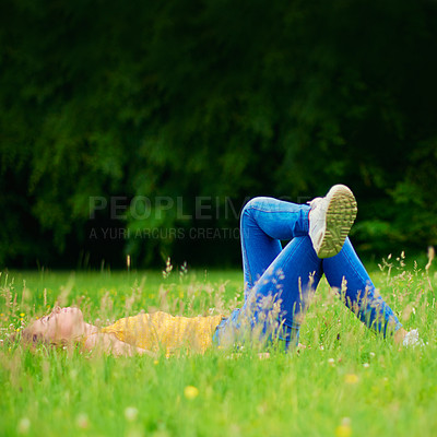 Buy stock photo Woman, relax and grass in nature field, calm and happiness in spring for weekend break with student on holiday. Laying, sleep and resting in park on ground, female person and peaceful outside