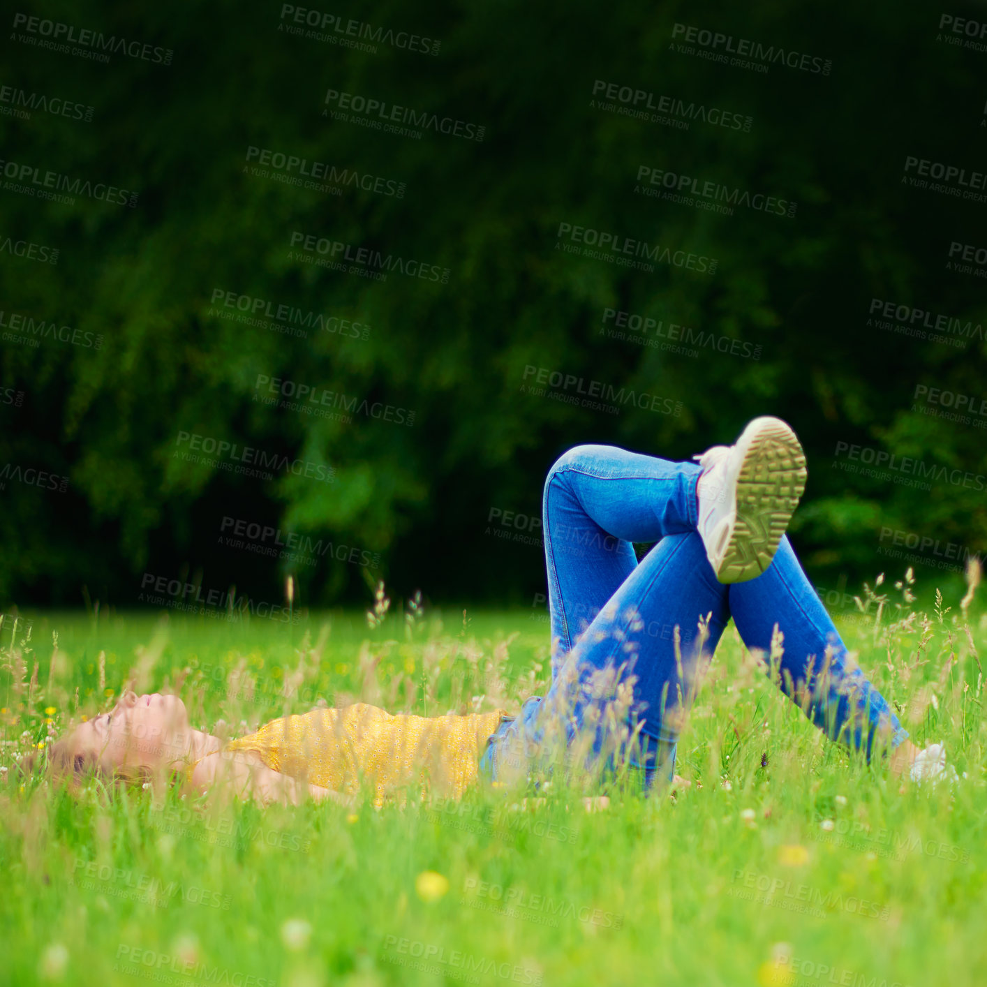Buy stock photo Woman, relax and grass in nature field, calm and happiness in spring for weekend break with student on holiday. Laying, sleep and resting in park on ground, female person and peaceful outside