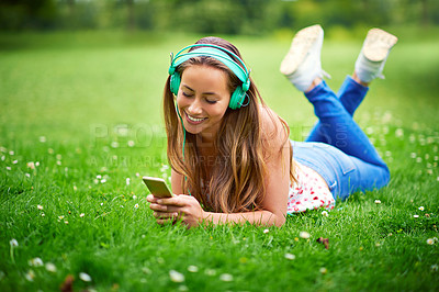 Buy stock photo Woman, phone and music on grass with headphones, lying and smile for listening, memory and thinking in spring. Girl, student and reflection with smartphone at campus for streaming subscription on web