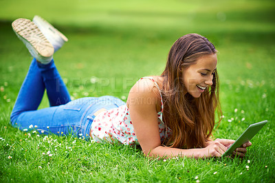 Buy stock photo Relax, happy and woman in park on tablet for online learning, internet and university website. College, higher education and person on digital tech for social media, research and working outdoors