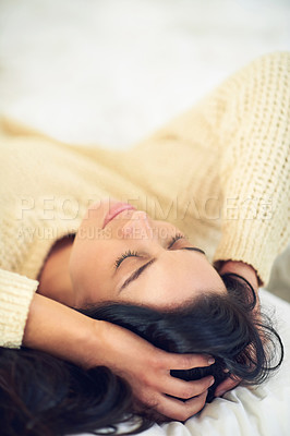 Buy stock photo Cropped shot of a young woman sleeping on her bed