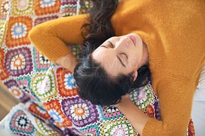 Buy stock photo High angle shot of a young woman sleeping on her bed