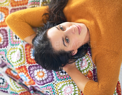 Buy stock photo High angle portrait of a young woman lying on her bed