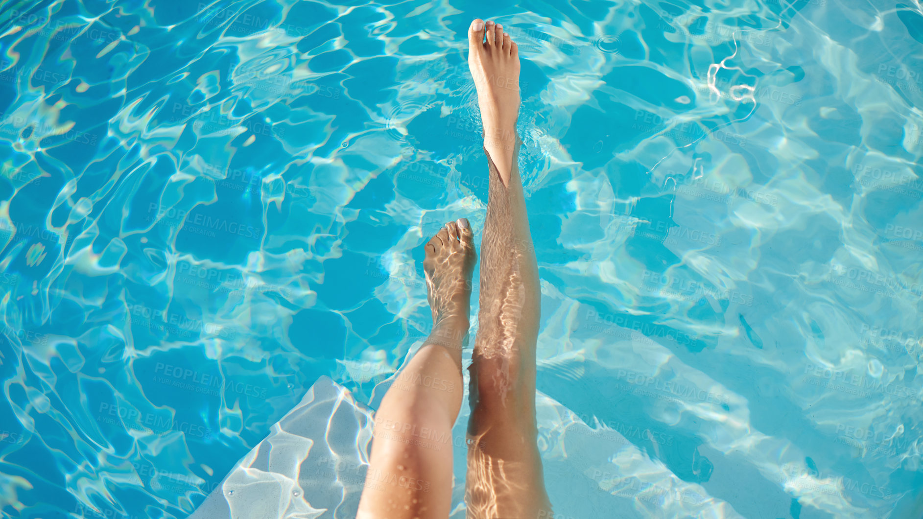 Buy stock photo Cropped shot of a woman's legs in the water of a swimming pool