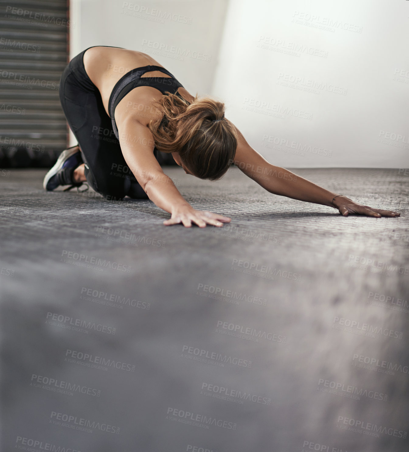 Buy stock photo Woman, gym and floor with stretching for back with arms, exercise or fitness for health. Female person, flexible and hands out for wellness with training, commitment to sport or workout with care