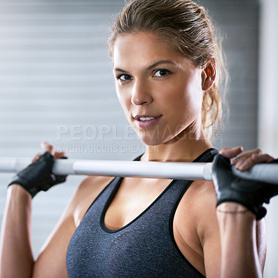 Buy stock photo Cropped portrait of a young woman working out with a barbell at the gym