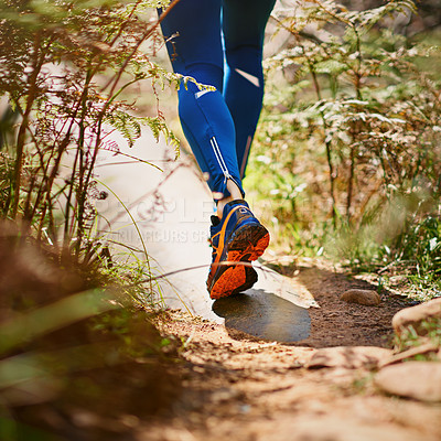 Buy stock photo Cropped shot of a man's legs as he's running along a nature trail