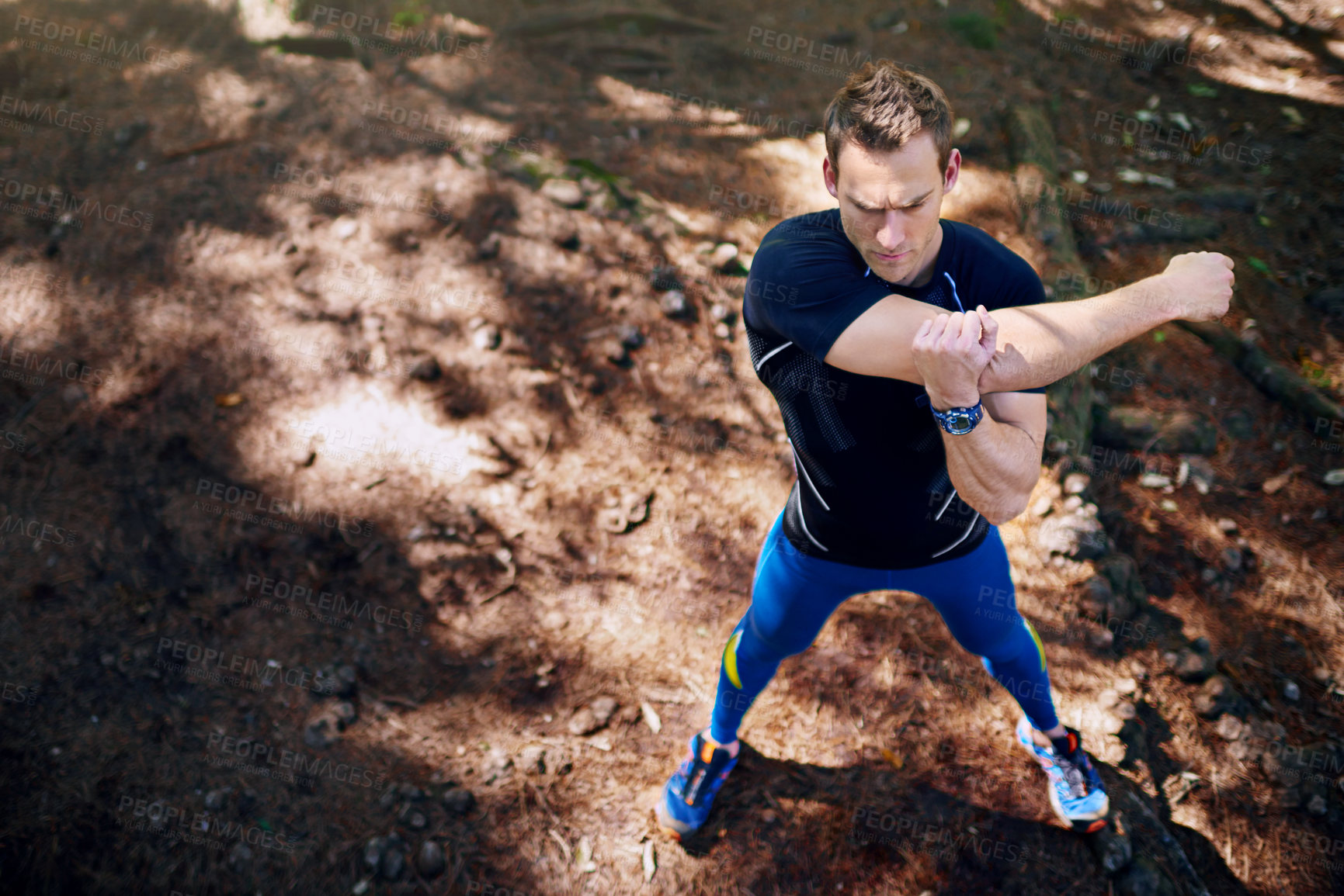 Buy stock photo Man, stretching and arms in forest for exercise or running, workout and wellness training for wellbeing. Male person, athlete and warm up in nature outdoor for marathon, physical activity and fit.