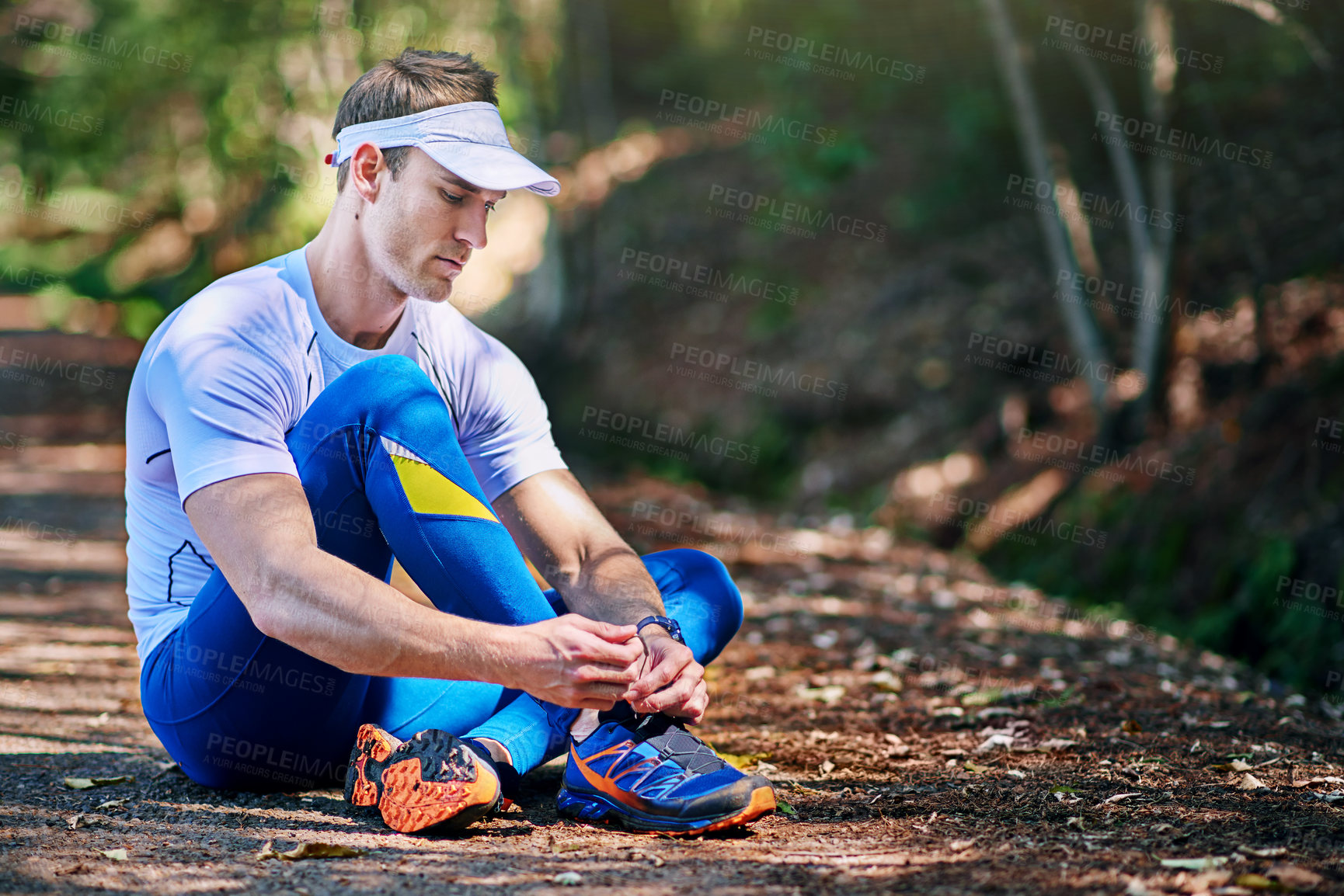 Buy stock photo Nature, fitness and man tie shoes before workout for cardio, running or marathon training. Floor, feet and legs of runner for prepare, fasten sneakers or ready to start physical activity in forest