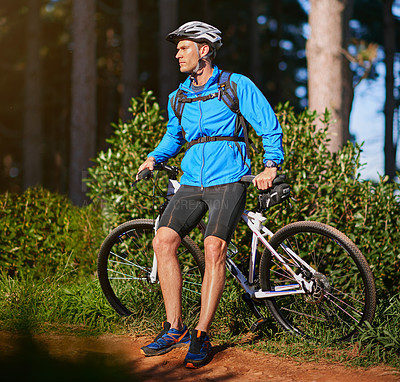 Buy stock photo Shot of a male cyclist out for a ride on his mountain bike