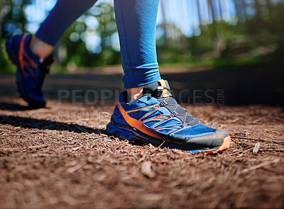 Buy stock photo Cropped shot of a man's legs as he's running along a trail