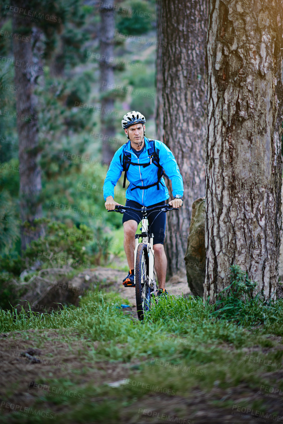 Buy stock photo Man, cycling and mountain bike in nature with grass, mud and off road for fitness, adventure and health. Cyclist, bicycle and exercise outdoor in forest for workout, sports and training with trees