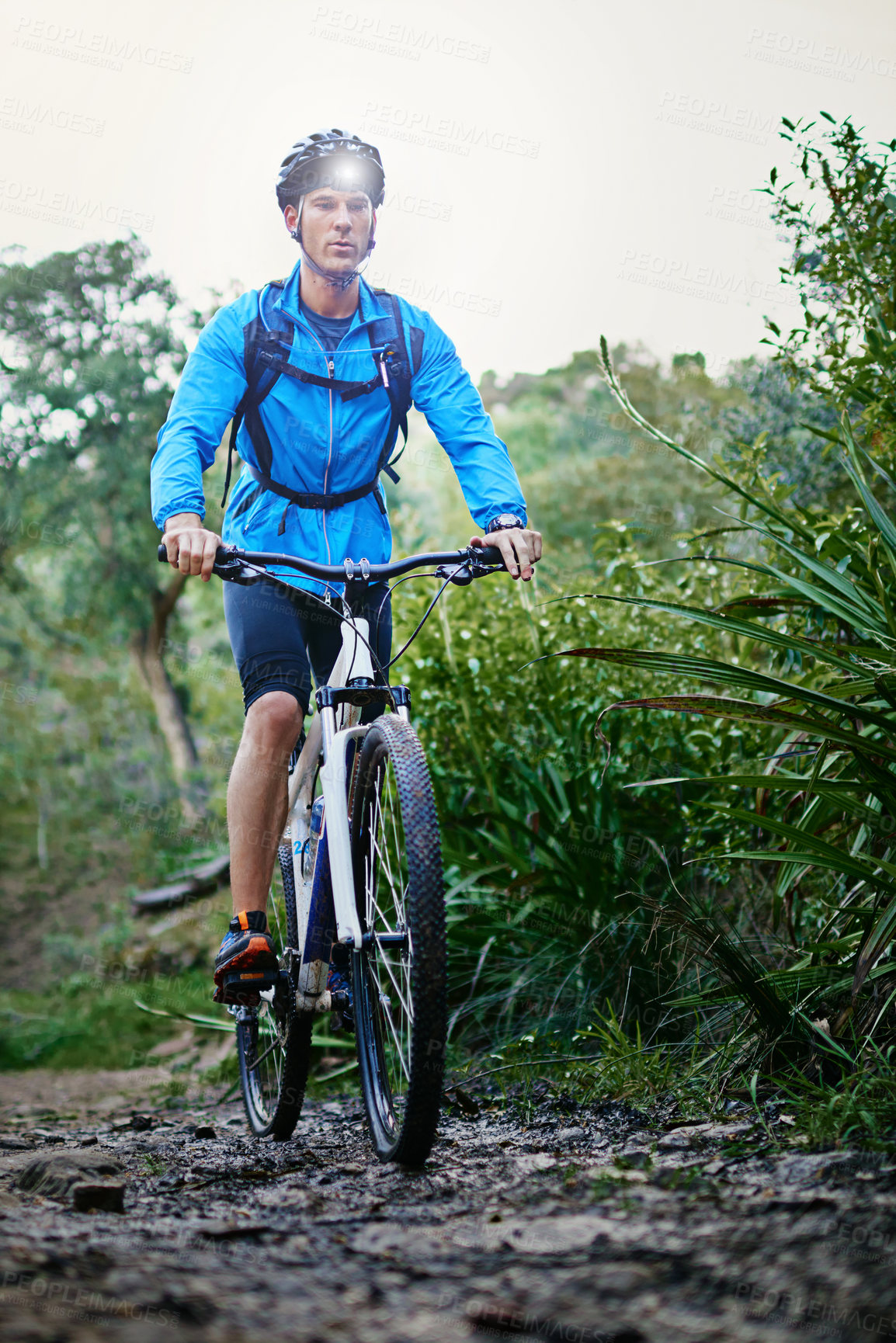 Buy stock photo Shot of a male cyclist riding along a mountain bike trail