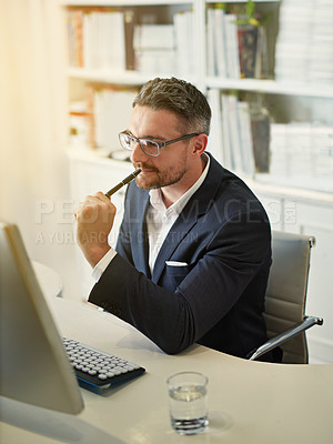 Buy stock photo Shot of a businessman working at his computer in an office