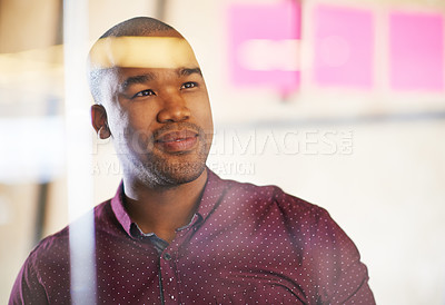 Buy stock photo Shot of a male designer looking at sticky notes on a glass wall